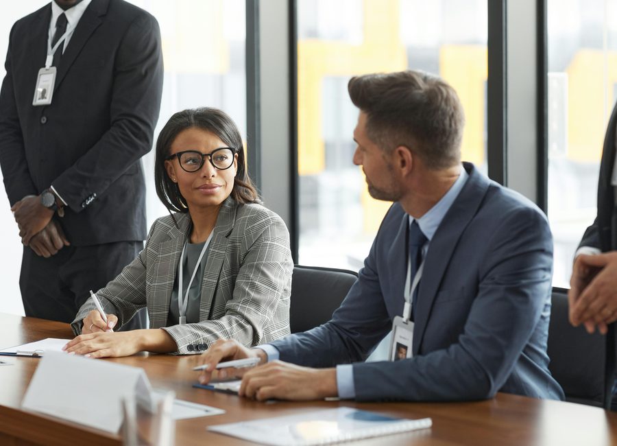 Business professionals discussing meeting requirements